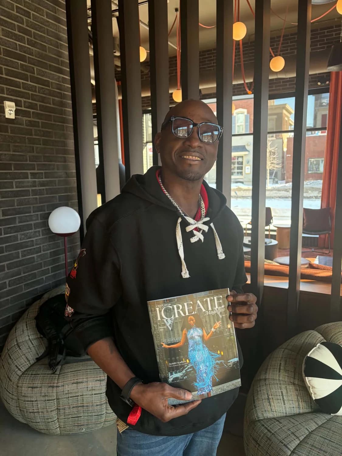Guest poses with an issue of I Create Magazine