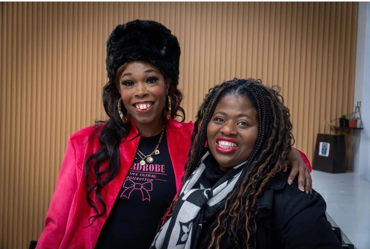 Two community members share a portrait