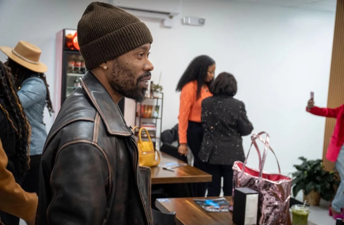 Guest in a black leather jacket at a community event